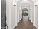 Inviting hallway features arched doorways, decorative lighting, and wood-look tile flooring at 22262 E Cherrywood Ct, Queen Creek, AZ 85142