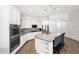 Modern kitchen with white cabinets, stainless steel appliances, a granite island with seating and neutral paint at 22262 E Cherrywood Ct, Queen Creek, AZ 85142