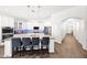 Bright, airy kitchen with island seating, stainless steel appliances, and white cabinetry at 22262 E Cherrywood Ct, Queen Creek, AZ 85142