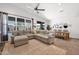 Bright living area features a large sectional, dining area, and expansive windows at 22262 E Cherrywood Ct, Queen Creek, AZ 85142