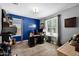 Home office with natural light, wood floors, and a functional workspace at 22262 E Cherrywood Ct, Queen Creek, AZ 85142
