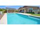 Refreshing backyard pool with a pergola, seating area, and well-manicured landscaping at 22262 E Cherrywood Ct, Queen Creek, AZ 85142