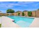 Sparkling pool featuring a basketball hoop and lush landscaping, ideal for relaxing and enjoying outdoor recreation at 22262 E Cherrywood Ct, Queen Creek, AZ 85142