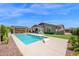 Sparkling pool, basketball hoop, covered patio and low maintenance turf make a great backyard at 22262 E Cherrywood Ct, Queen Creek, AZ 85142