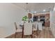 Cozy dining area with a round table, four chairs, and adjacent access to the kitchen at 2301 E University Dr # 233, Mesa, AZ 85213