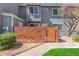 Charming two-story home with a brick wall, wooden gate and freshly manicured lawn at 2301 E University Dr # 233, Mesa, AZ 85213