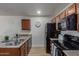 Bright kitchen with granite countertops, stainless steel sink and black appliances at 2301 E University Dr # 233, Mesa, AZ 85213