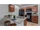 Well-lit kitchen with modern, black appliances, granite counters, breakfast bar and wood cabinets at 2301 E University Dr # 233, Mesa, AZ 85213
