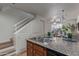 Kitchen with granite countertops, stainless sink, and open access to staircase and living area at 2301 E University Dr # 233, Mesa, AZ 85213