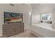 Main bedroom featuring ample natural light, TV, and access to ensuite bathroom at 2301 E University Dr # 233, Mesa, AZ 85213