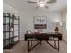 Well-lit office space featuring stylish dark wood desk, shelving and ceiling fan at 2301 E University Dr # 233, Mesa, AZ 85213