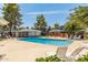 A relaxing pool is surrounded by lounge chairs and mature trees, offering a refreshing outdoor space for residents at 2301 E University Dr # 233, Mesa, AZ 85213