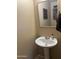 Bathroom with white pedestal sink and neutral decor at 2411 W Lucia Dr, Phoenix, AZ 85085