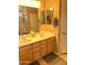 Bathroom featuring double sinks with wooden vanity and cabinet space below at 2411 W Lucia Dr, Phoenix, AZ 85085