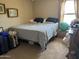 Modest bedroom with a comfortable bed and neutral carpet, showcasing a simple and functional layout at 2411 W Lucia Dr, Phoenix, AZ 85085