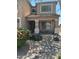 Inviting front porch with desert landscaping, rocks and flowering bushes at 2411 W Lucia Dr, Phoenix, AZ 85085