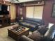 Cozy living room featuring leather couches, a ceiling fan, and a TV at 2411 W Lucia Dr, Phoenix, AZ 85085