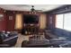 Spacious living room with leather couches, a TV, and a ceiling fan at 2411 W Lucia Dr, Phoenix, AZ 85085