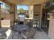 This covered patio includes a full outdoor kitchen, dining set, and 'Cowboys' themed decor at 2411 W Lucia Dr, Phoenix, AZ 85085