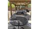 This outdoor living space is equipped with a large gazebo, dining table, grill, and comfortable sectional seating at 2411 W Lucia Dr, Phoenix, AZ 85085