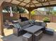 Relax in style with this outdoor living space featuring a shaded gazebo and comfortable seating area at 2411 W Lucia Dr, Phoenix, AZ 85085