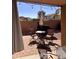 This covered outdoor patio features pavers, seating, brick surround and relaxing string lights at 2411 W Lucia Dr, Phoenix, AZ 85085