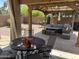 Covered patio with a dining area, seating and barbecue, perfect for outdoor gatherings and relaxation at 2411 W Lucia Dr, Phoenix, AZ 85085
