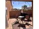 This covered outdoor patio features pavers, seating, brick surround and relaxing string lights at 2411 W Lucia Dr, Phoenix, AZ 85085