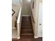 Wooden staircase with white accents and natural light, leading to the upper levels of the home at 2411 W Lucia Dr, Phoenix, AZ 85085