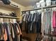 Walk-in closet with organized hanging clothes and overhead shelves at 2411 W Lucia Dr, Phoenix, AZ 85085