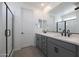 Bathroom featuring double sinks with sleek fixtures and a modern shower, blending style and functionality at 24232 W Agora Ln, Buckeye, AZ 85326