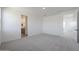 A bright bedroom features neutral walls, soft carpet, and an ensuite bathroom, offering a tranquil retreat at 24232 W Agora Ln, Buckeye, AZ 85326