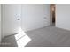 Bright bedroom featuring two doors, neutral walls, and soft carpet, providing a serene and comfortable space at 24232 W Agora Ln, Buckeye, AZ 85326