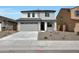 Two-story home boasts a minimalist landscaped front yard and attached two-car garage at 24232 W Agora Ln, Buckeye, AZ 85326