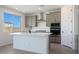 Bright kitchen features quartz counters, stainless steel appliances, and modern gray cabinets at 24232 W Agora Ln, Buckeye, AZ 85326