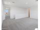 Upstairs living room with neutral carpet and walls provides a large, versatile space at 24232 W Agora Ln, Buckeye, AZ 85326