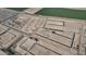 An aerial view of a new home community showcasing plots ready for development and roads at 24249 W Agora Ln, Buckeye, AZ 85326