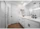 Modern bathroom with double sinks, white cabinets, shower with glass door, and tile floors at 24249 W Agora Ln, Buckeye, AZ 85326