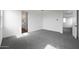 Spacious bedroom with carpet floors, neutral white walls, and hallway and bathroom access at 24249 W Agora Ln, Buckeye, AZ 85326