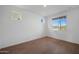 Bedroom featuring light tile floors, neutral white walls, and bright window for ample natural light at 24249 W Agora Ln, Buckeye, AZ 85326