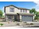 Charming two-story home with neutral colored stucco, stone accents, gray trim, and a two car garage at 24249 W Agora Ln, Buckeye, AZ 85326