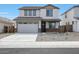 Two-story home featuring a two car garage, neutral paint, and low maintenance desert landscaping at 24249 W Agora Ln, Buckeye, AZ 85326