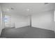 Upstairs loft with carpeted floors, bright white walls, and staircase and hallway access at 24249 W Agora Ln, Buckeye, AZ 85326