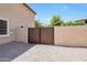 Backyard view of the gate and landscaped rock with access to utilities at 2726 S 160Th Ave, Goodyear, AZ 85338
