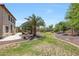 Expansive backyard features mature trees, lush grass, decorative rock features and a covered patio at 2726 S 160Th Ave, Goodyear, AZ 85338