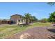 Expansive backyard features desert landscaping and rock, mature trees and a covered patio at 2726 S 160Th Ave, Goodyear, AZ 85338