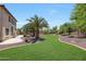 An expansive backyard featuring well-maintained grass, palm trees, and elegant landscaping at 2726 S 160Th Ave, Goodyear, AZ 85338
