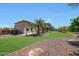 Spacious backyard with mature trees, well-maintained grass, and a patio area, perfect for outdoor living at 2726 S 160Th Ave, Goodyear, AZ 85338