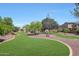 Spacious backyard featuring lush green grass and mature trees, plus decorative rock ground cover at 2726 S 160Th Ave, Goodyear, AZ 85338