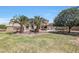 Expansive backyard features palm trees, lush green grass, and a covered patio perfect for outdoor living at 2726 S 160Th Ave, Goodyear, AZ 85338